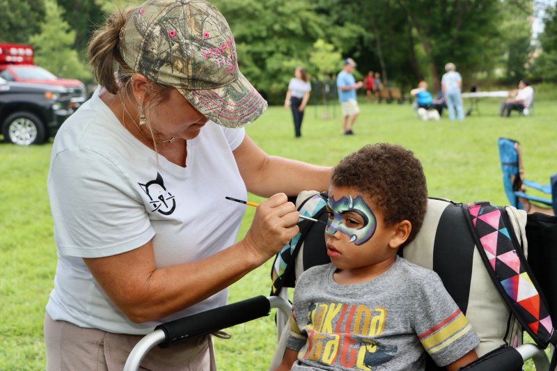 Catherine Flaherty of Copy Cat Paint Parties, left, paints Elias Sanchez.